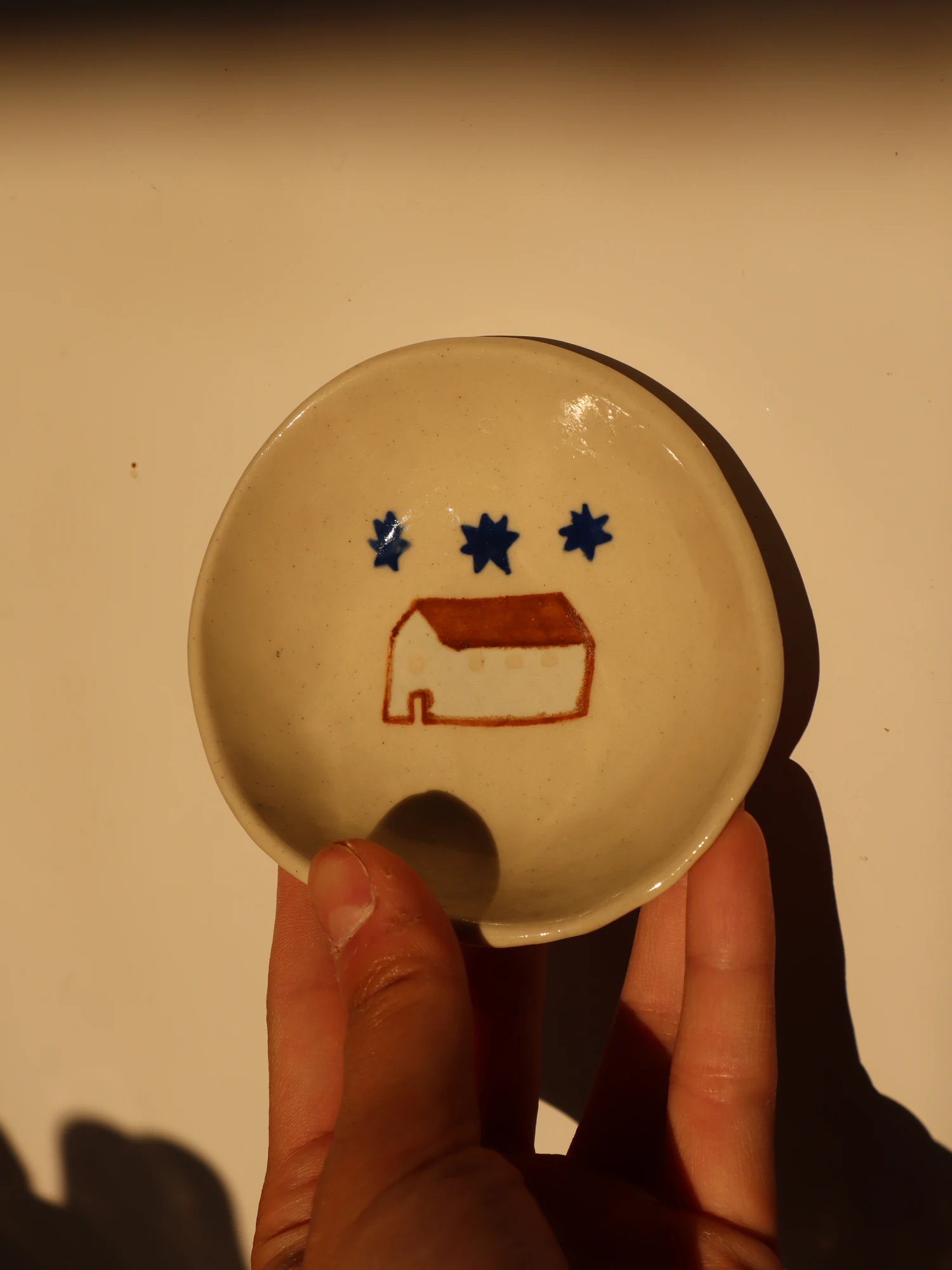 Ceramic trinket dish with house and star illustration
