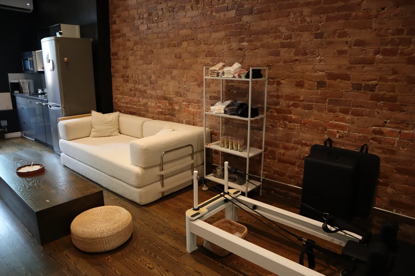 Quiet corner of SAH Studio with reformer equipment and sofa
