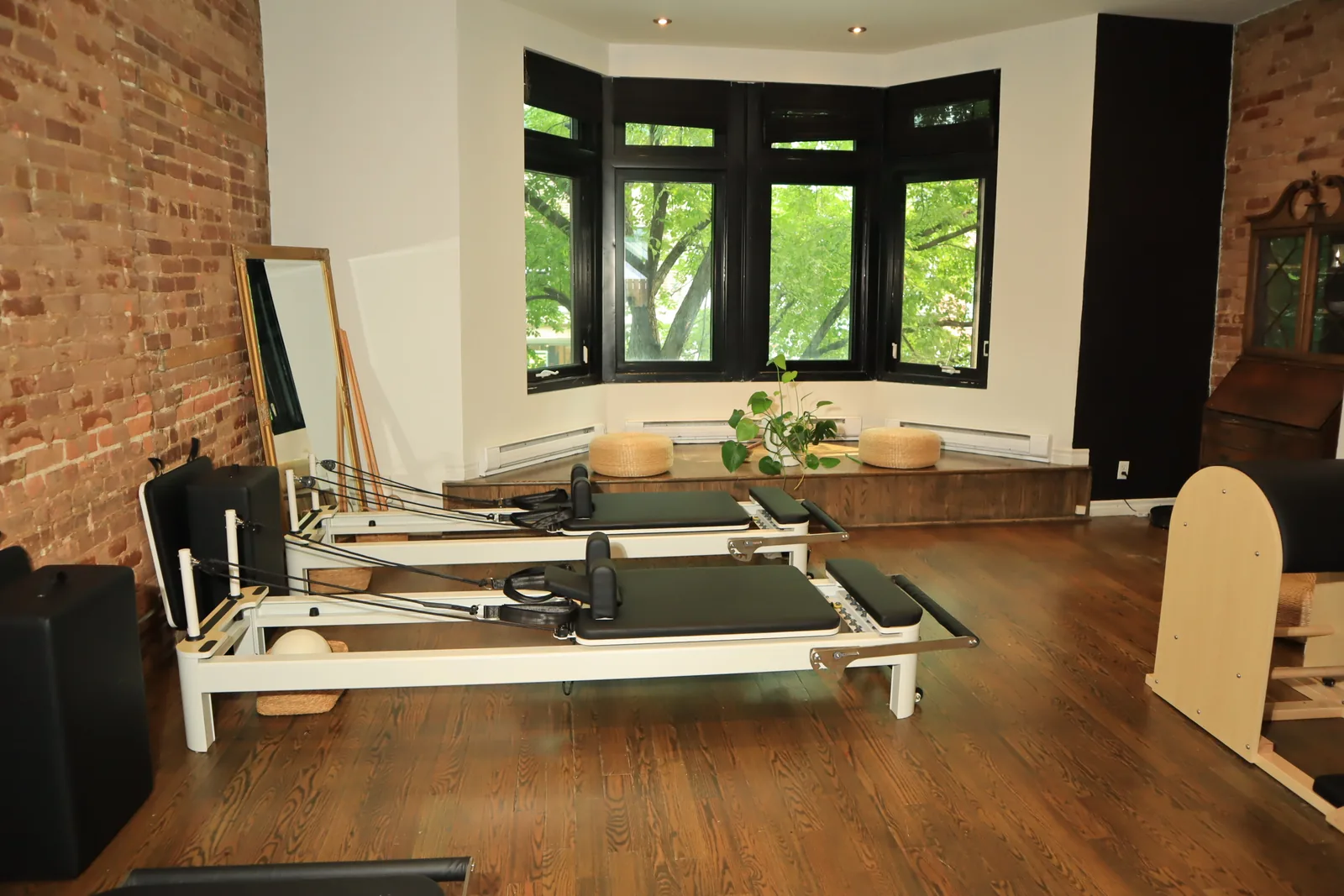 SAH Studio reformer Pilates room with exposed brick and three reformers